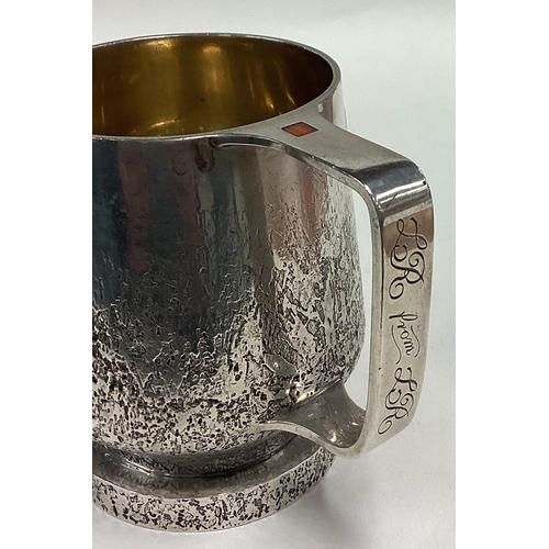 288 - An unusual hammered silver mug with stone decoration to handle. London 1984. By PGW. Approx. 329 gra... 