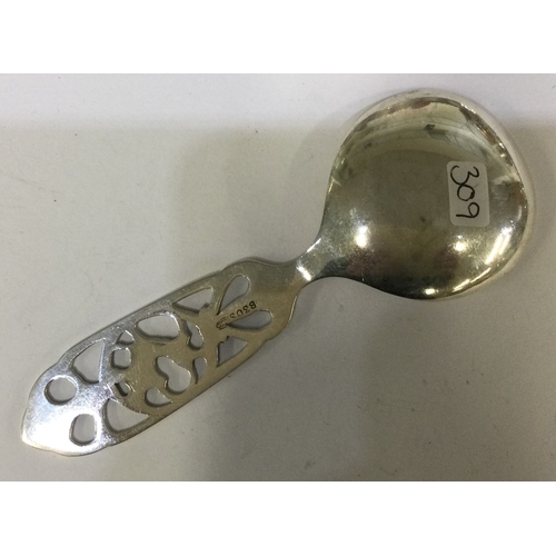 309 - A silver caddy spoon pierced with horse decoration. Approx. 22 grams. Est. £20 - £30.