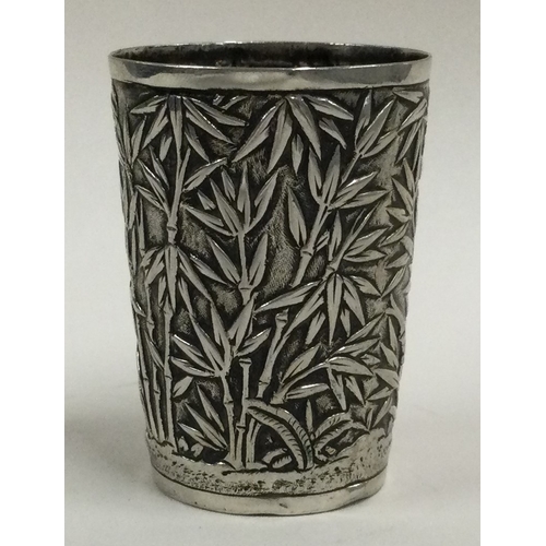 312 - A 19th Century Chinese export silver beaker with chased bamboo decoration. Marked to base. Approx. 2... 