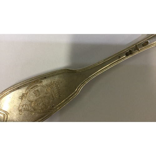 330 - An 18th Century French silver tablespoon with central armorial. Approx. 83 grams. Est. £80 - £120.