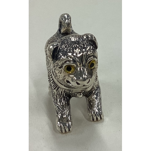 34 - A Sterling silver figure of a dog with yellow eyes. Approx. 14 grams. Est. £20 - £30.