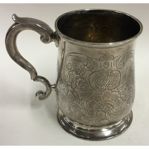 344 - An early George II silver mug engraved with floral decoration. 1732. By Thomas Mason. Approx. 190 gr... 