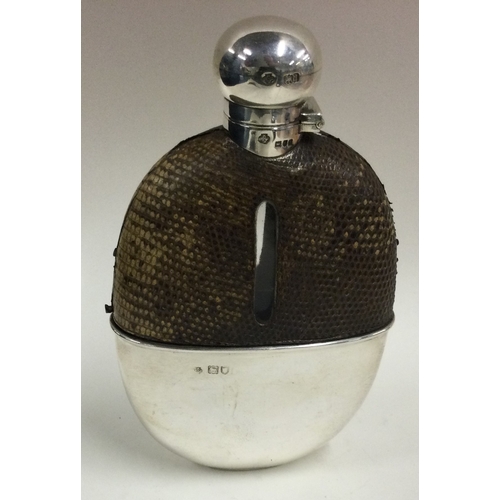 348 - A large Victorian silver and glass flask with leather cover. London 1899. By William Hutton & Sons. ... 