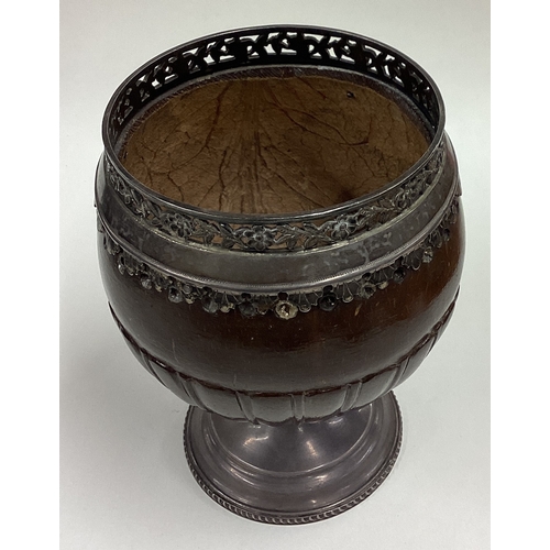 36 - A large early 18th Century Provincial coconut cup with pierced floral border and coin to centre. App... 