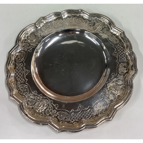 370 - A chased 18th Century silver dish with embossed figural decoration. Approx. 341 grams. Est. £250 - £... 