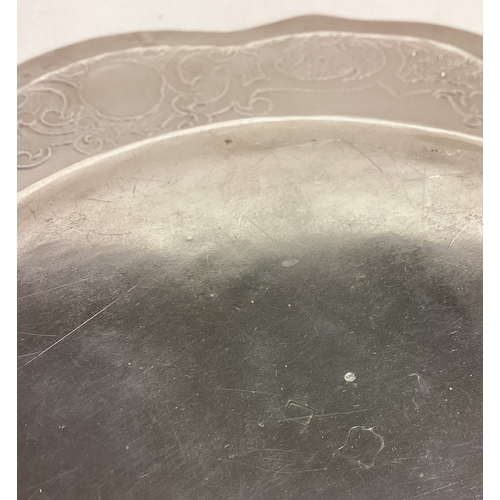 370 - A chased 18th Century silver dish with embossed figural decoration. Approx. 341 grams. Est. £250 - £... 