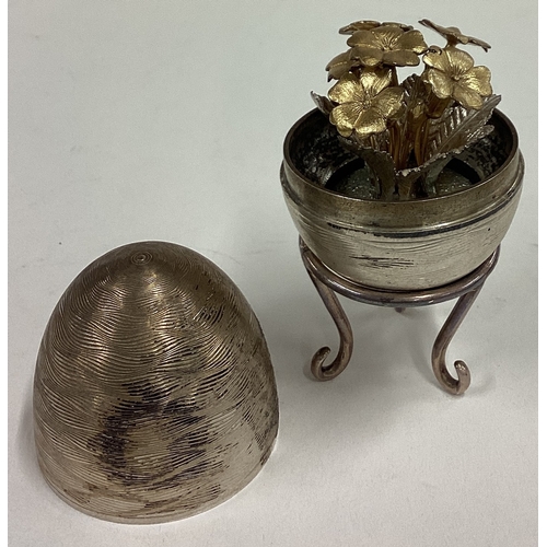 381 - A silver surprise egg with stand. London 2000. Approx. 116 grams. Est. £120 - £150.