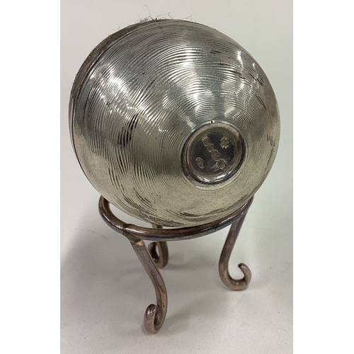 381 - A silver surprise egg with stand. London 2000. Approx. 116 grams. Est. £120 - £150.