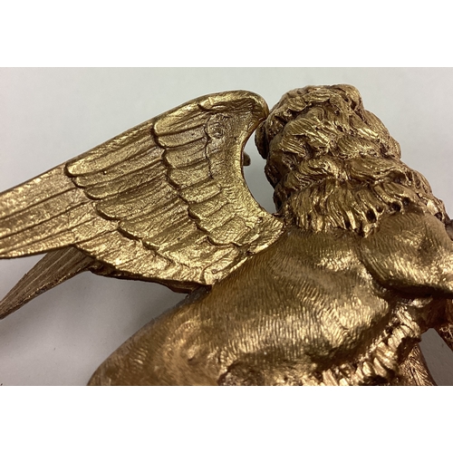 382 - A pair of silver gilt 'Cannes Festival' griffin figures. Marked to book and plinth. Est. £400 - £600... 