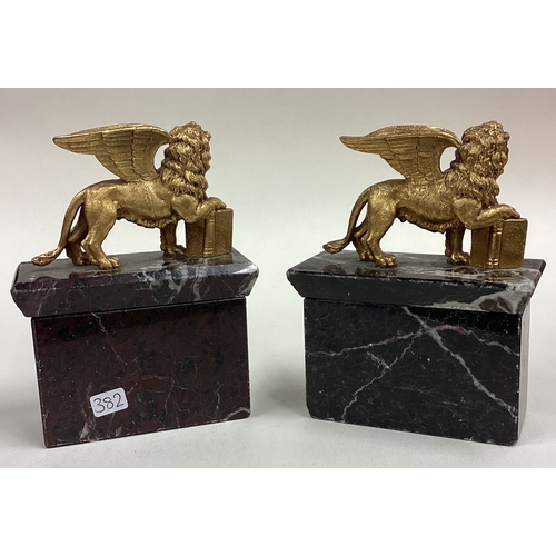 382 - A pair of silver gilt 'Cannes Festival' griffin figures. Marked to book and plinth. Est. £400 - £600... 