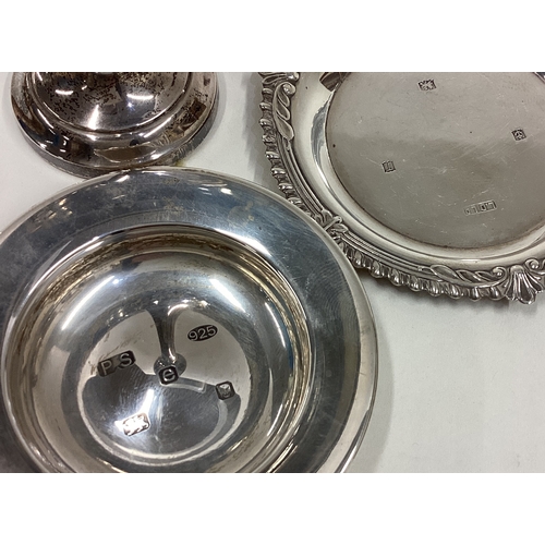 40 - Two silver pin dishes together with a spill vase. Approx. 122 grams of gross weight. Est. £30 - £50.