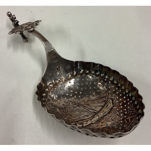 411 - OF NAUTICAL INTEREST: A chased Dutch silver caddy spoon with pierced decoration. Marked 930. Approx.... 