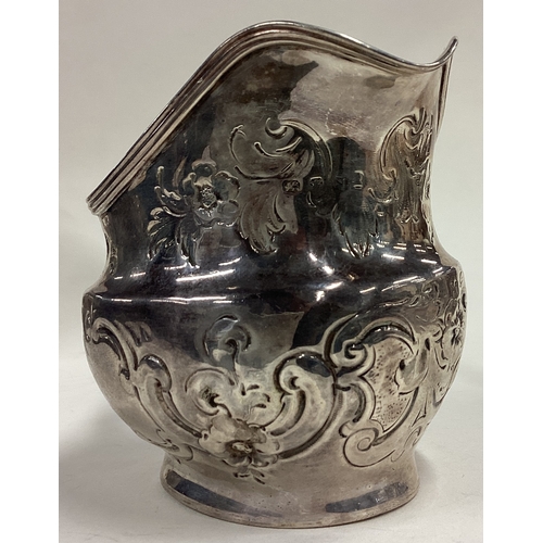 421 - A George III silver jug with chased decoration. London 1808. Approx. 106 grams. Est. £80 - £120.