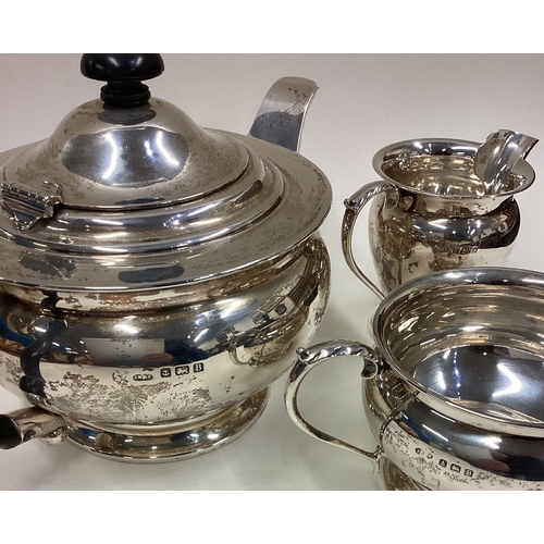 43 - A good circular silver three-piece tea set on pedestal bases. Approx. 340 grams. Est. £200 - £300.