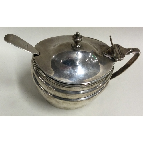 447 - A Georgian silver mustard pot with BGL and spoon. London 1806. Approx. 123 grams. Est. £80 - £120.