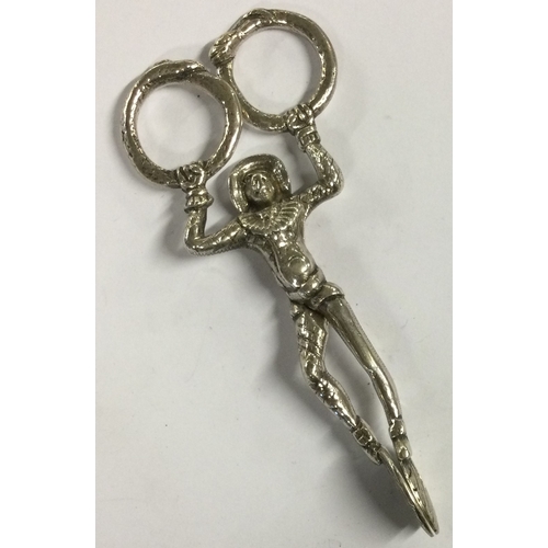 483 - A pair of Antique silver ice tongs in the form of a Harlequin. Approx. 60 grams. Est. £50 - £80.