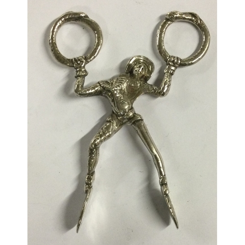 483 - A pair of Antique silver ice tongs in the form of a Harlequin. Approx. 60 grams. Est. £50 - £80.