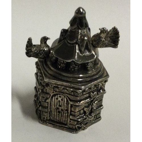 489 - A heavy silver pill box in the form of a castle with lift-off cover embossed with birds. Approx. 65 ... 