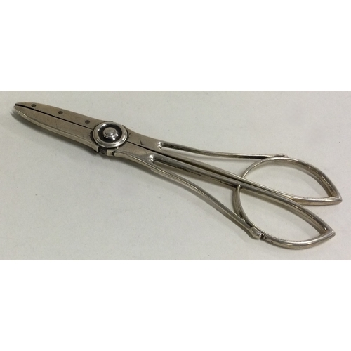 515 - A pair of large silver grape scissors. Marked Sterling. Approx. 81 grams. Est. £80 - £120.