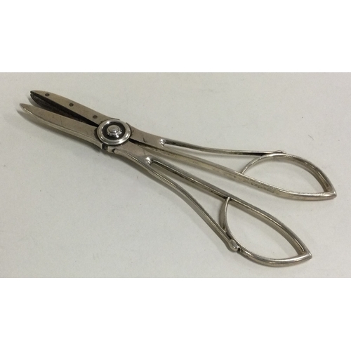 515 - A pair of large silver grape scissors. Marked Sterling. Approx. 81 grams. Est. £80 - £120.