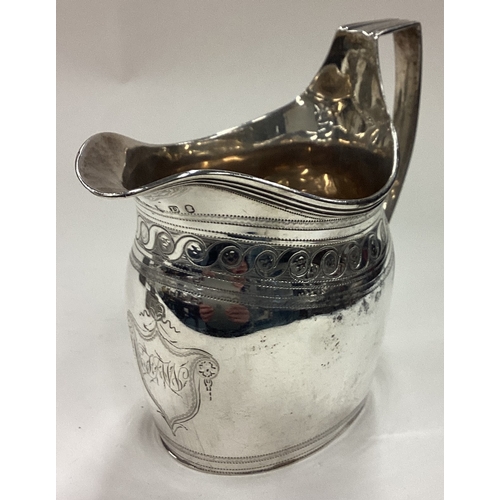 516 - A George III silver jug with bright-cut decoration. London 1799. By Robert & David Hennell. Approx. ... 