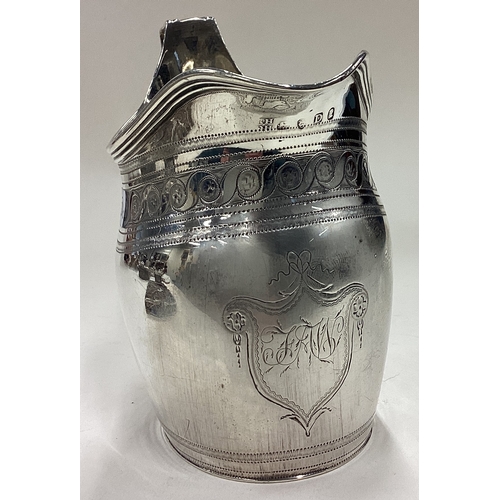 516 - A George III silver jug with bright-cut decoration. London 1799. By Robert & David Hennell. Approx. ... 