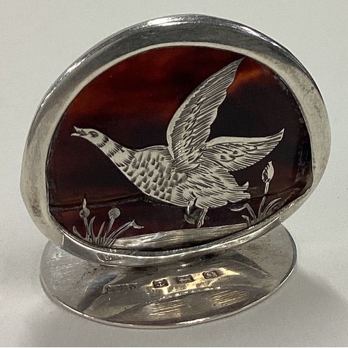 558 - An Edwardian silver and tortoiseshell menu holder depicting a bird. 1906. Approx. 12 grams. Est. £50... 