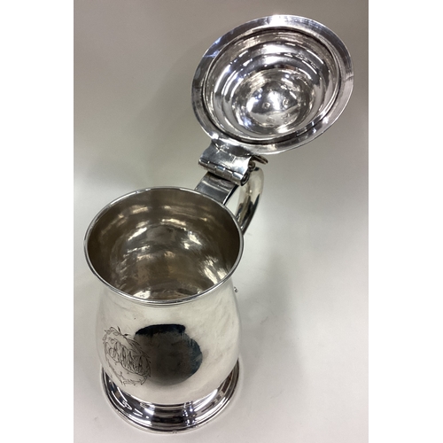 564 - A good quality plain George III silver dome topped tankard with pierced thumb piece to pedestal base... 