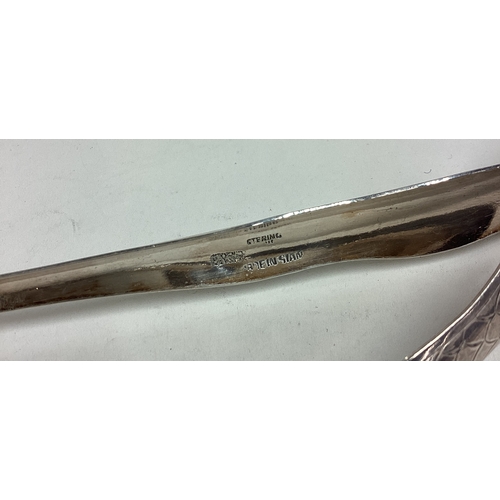 575 - A large pair of silver ice tongs. Marked Sterling. Approx. 51 grams. Est. £50 - £80.