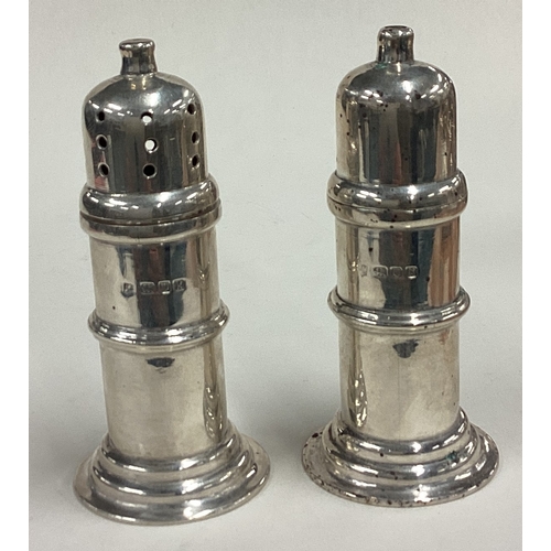 589 - A pair of silver salt and pepper shakers. London 1945. Approx. 144 grams. Est. £120 - £150.