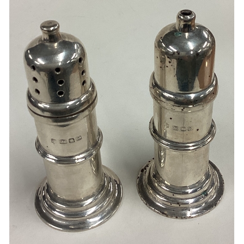 589 - A pair of silver salt and pepper shakers. London 1945. Approx. 144 grams. Est. £120 - £150.