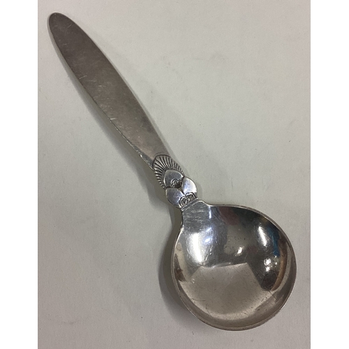 609 - GEORG JENSEN: A large caddy spoon of typical form with tapering handle. Approx. 34 grams. Est. £40 -... 