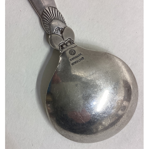 609 - GEORG JENSEN: A large caddy spoon of typical form with tapering handle. Approx. 34 grams. Est. £40 -... 