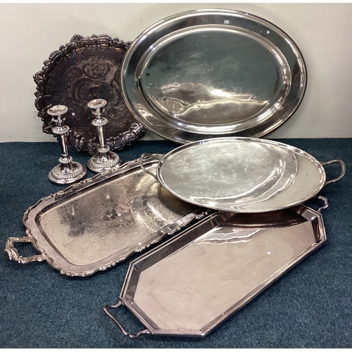 618 - Four good silver plated gallery trays together with a salver and candlesticks. Est. £20 - £30.