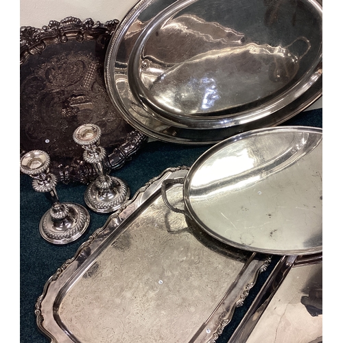 618 - Four good silver plated gallery trays together with a salver and candlesticks. Est. £20 - £30.