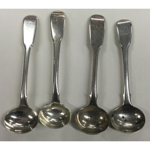 672 - A group of four heavy silver fiddle pattern salt spoons. Various dates and makers. Approx. 50. grams... 