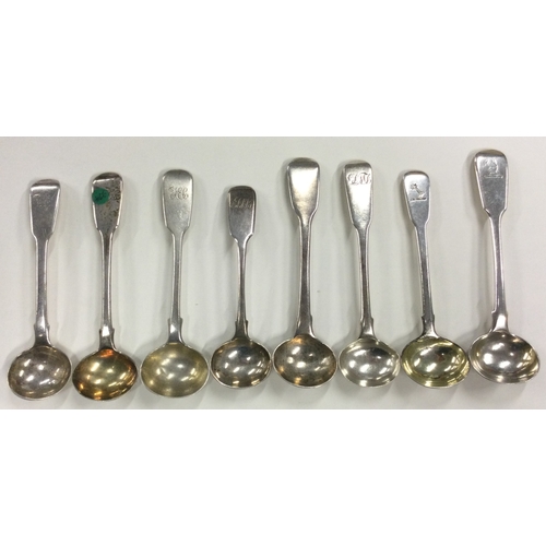 679 - A group of eight silver fiddle pattern salt spoons. Various dates and makers. Approx. 100 grams. Est... 