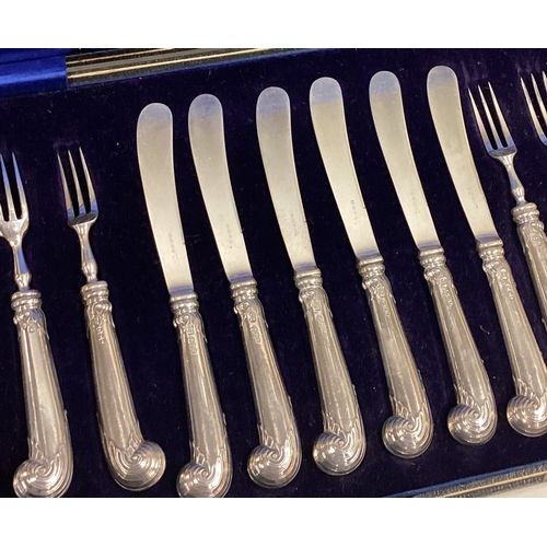 696 - A good boxed set of six plus six silver handled cake knives and forks. Est. £40 - £50.