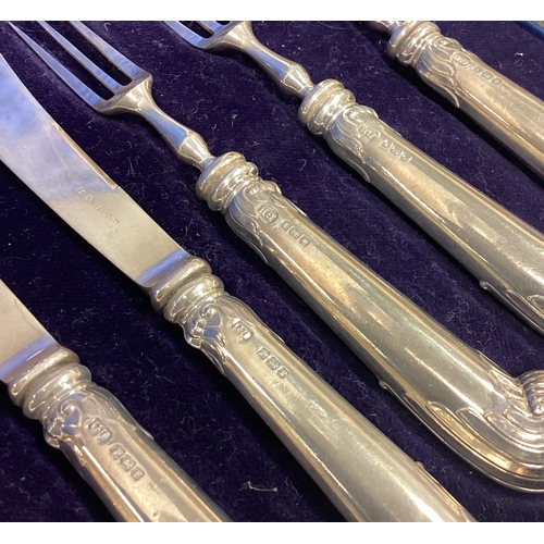 696 - A good boxed set of six plus six silver handled cake knives and forks. Est. £40 - £50.