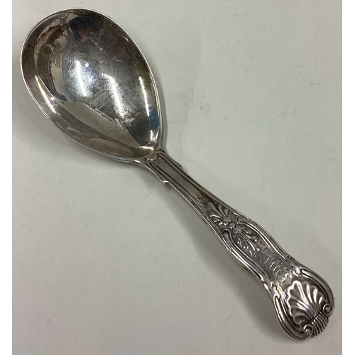 698 - A large silver honeysuckle pattern caddy spoon. London. By GA. Approx. 29 grams. Est. £30 - £50.