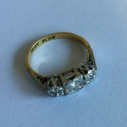 703 - A good Art Deco diamond three stone ring in 18 carat gold and platinum. Approx. 3 grams. Est. £100 -... 