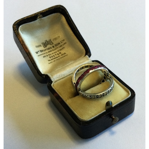 704 - A sapphire, ruby and diamond hinged 'night and day' ring set in platinum. Approx. 4 grams. Est. £250... 