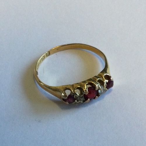 707 - A ruby and diamond five stone ring in 18 carat setting. Approx. 2 grams. Est. £100 - £150.