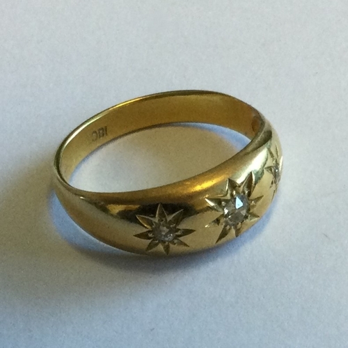 708 - A good diamond three stone gypsy set ring in 18 carat gold mount. Approx. 4 grams. Est. £150 - £200.