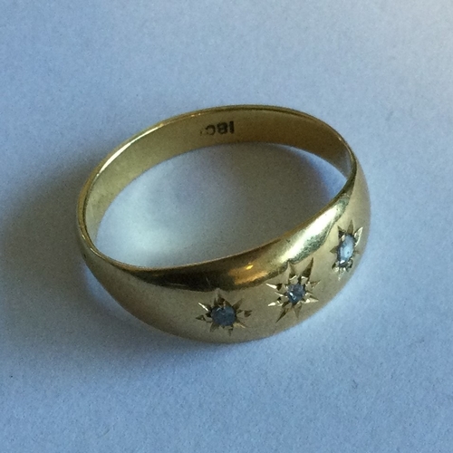 709 - A small diamond three stone gypsy set ring. Approx. 2 grams. Est. £100 - £150.