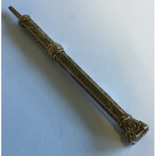 716 - A small gold engraved pencil with scroll decoration. Approx. 16 grams. Est. £50 - £80.