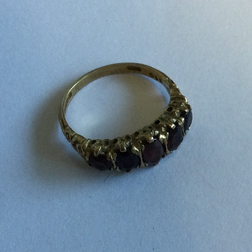 723 - A garnet five stone half hoop ring. Approx. 4 grams. Est. £40 - £60.