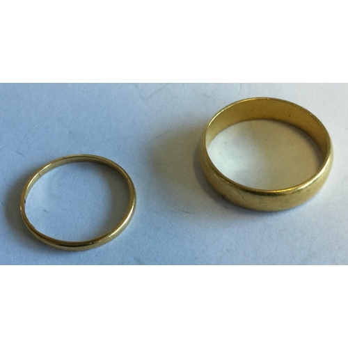 727 - Two small 18 carat gold wedding bands. Approx. 3 grams. Est. £100 - £150.