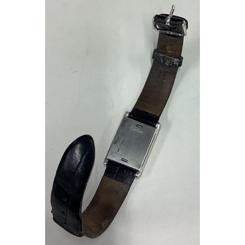 735 - CARTIER: A good lady's stainless steel wristwatch with silvered dial on black leather strap complete... 