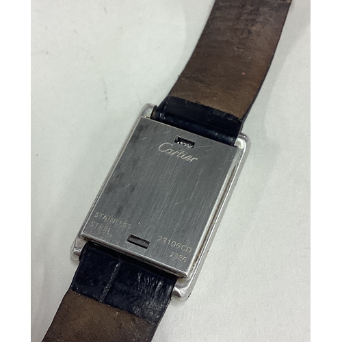 735 - CARTIER: A good lady's stainless steel wristwatch with silvered dial on black leather strap complete... 